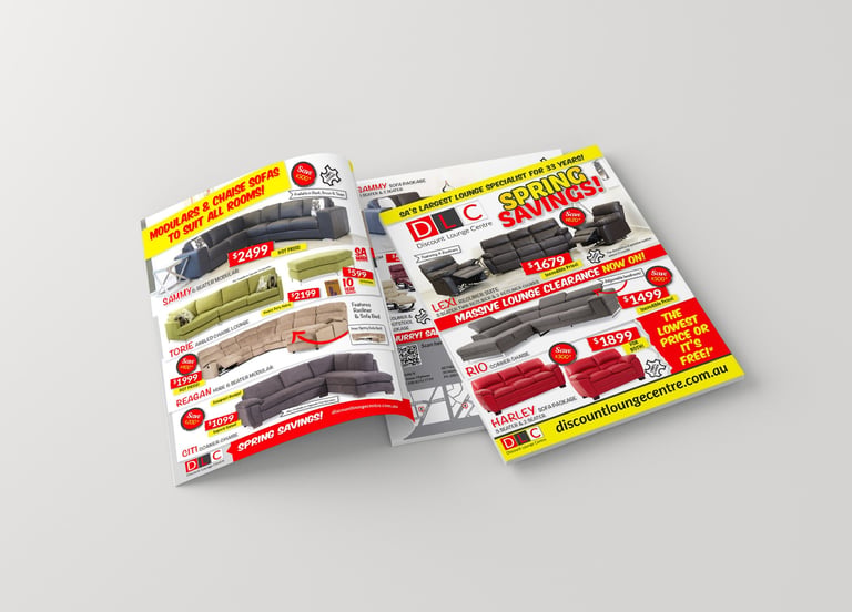 Stack of colorful grocery store coupons and sale flyers fanned out on a light background
